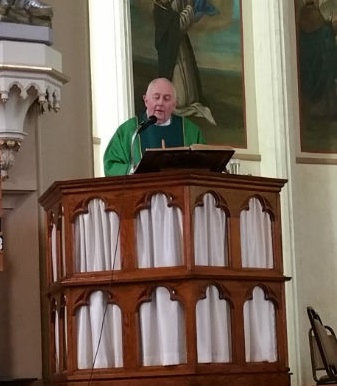 Fr. Brian Harrison delivers the homily at Mass.